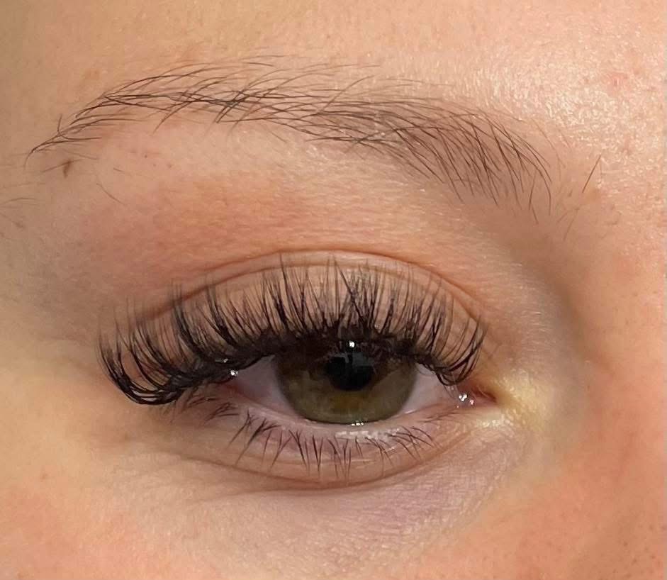 Green eye lash extension close-up